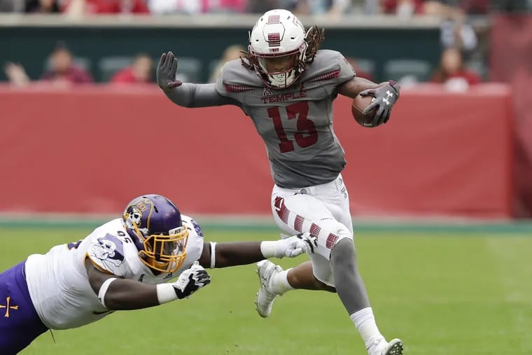 Temple punt returner Isaiah Wright runs past East Carolina special team member Bennett Boateng for a 59-yard punt return for a touchdown during the second-quarter on Saturday, October 6, 2018. YONG KIM / Staff Photographer