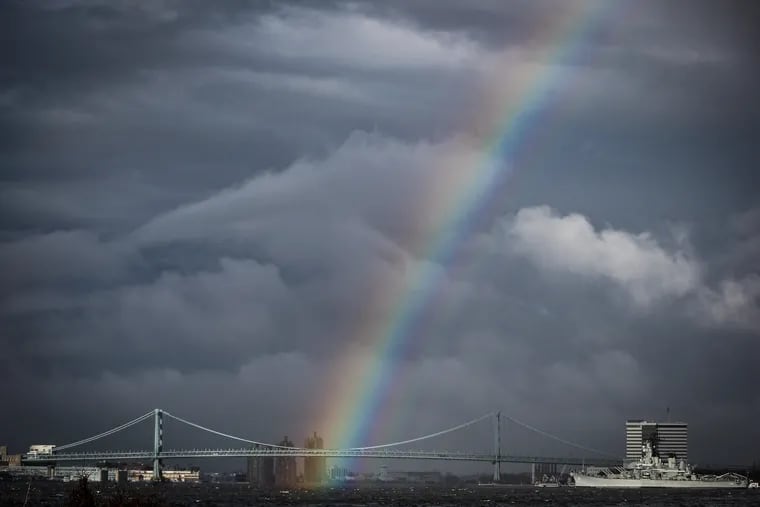 A rainbow appears over the Ben Franklin Bridge after a rain storm passed through Philadelphia, PA on December 30, 2019.