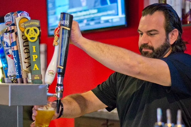 Waylon Nelson pours a drink for a guest at Masters, a bar and restaurant on Temple campus. October 16, 2014. Daily News Staff / Randi Fair