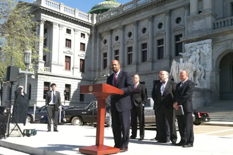 Mayor Nutter speaking in Harrisburg, where he joined mayors against bills that could end local gun laws. (Amy Worden / Staff)