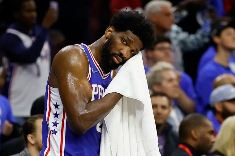 Sixers center Joel Embiid wipes his face late in the game against the Miami Heat during game three of the second-round Eastern Conference playoffs on Friday, May 6, 2022 in Philadelphia.