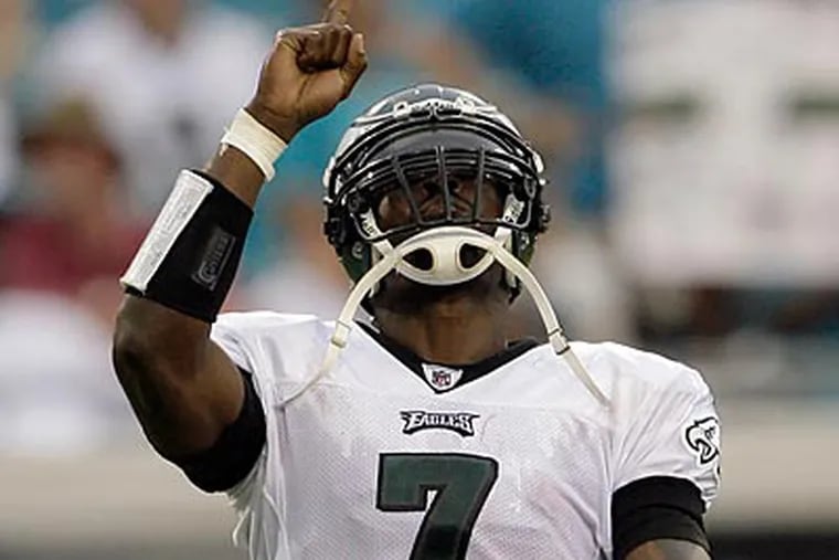 Michael Vick threw for three touchdowns and ran for a fourth in the Eagles' win. (Yong Kim/Staff Photographer)