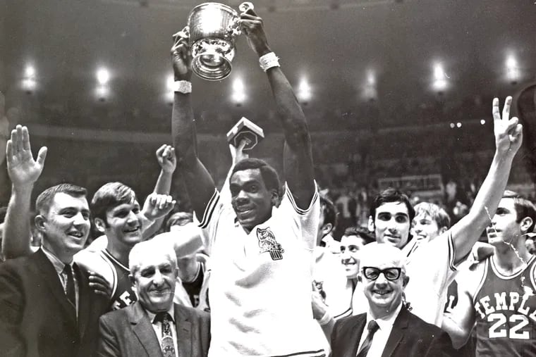 John Baum lifts the trophy as the Temple men's basketball team celebrates winning the NIT championship in March 1969.