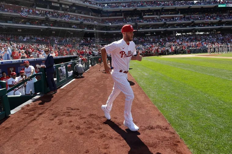 Phillies starting pitcher Zack Wheeler runs on the field during opening-day player introductions on Friday.