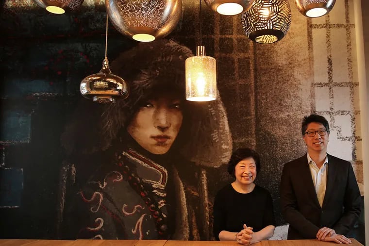Susanna Foo and her son Gabriel in front of a large mural inside the restaurant SUGA on Feb. 1, 2016.