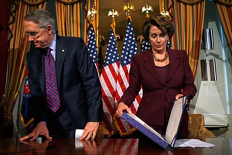 House Speaker Nancy Pelosi closes a box containing the war-funding bill that the president later vetoed. With her at the signing ceremony yesterday was Majority Leader Harry Reid.