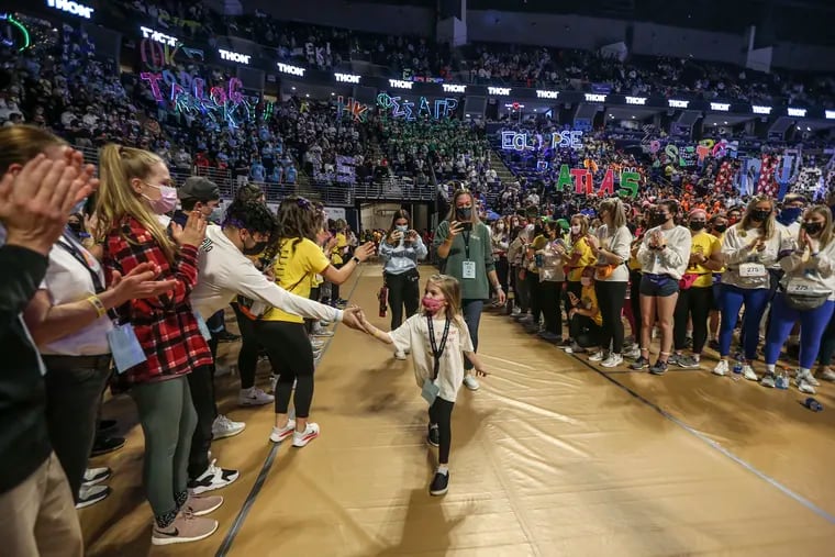 Pediatric cancer survivors and their families enter THON, Penn State's 46-hour dance marathon that raises money for pediatric cancer research and patient support.