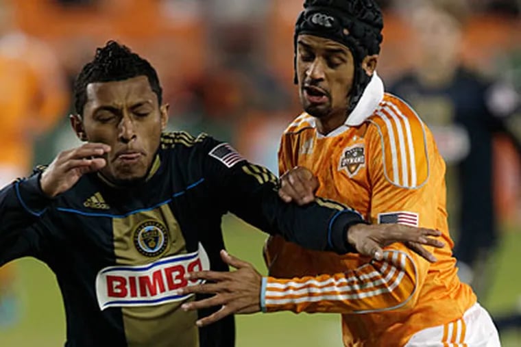 Union defender Carlos Valdes, left, was given a yellow card in Thursday's loss to the Dynamo. (AP/Houston Chronicle, Melissa Phillip)
