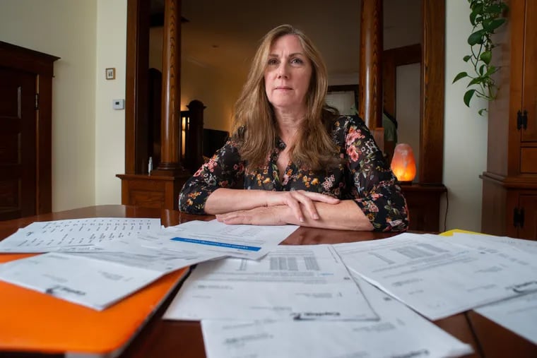 Leslie Robison sits amid a pile of paperwork from her travails with a growing type of credit fraud in which criminals buy cheap digital subscriptions that often go unnoticed by consumers. In January she found over a dozen charges at $1.99 for cloud storage she never ordered. In the end,she was billed 64 times on six cards over five months.