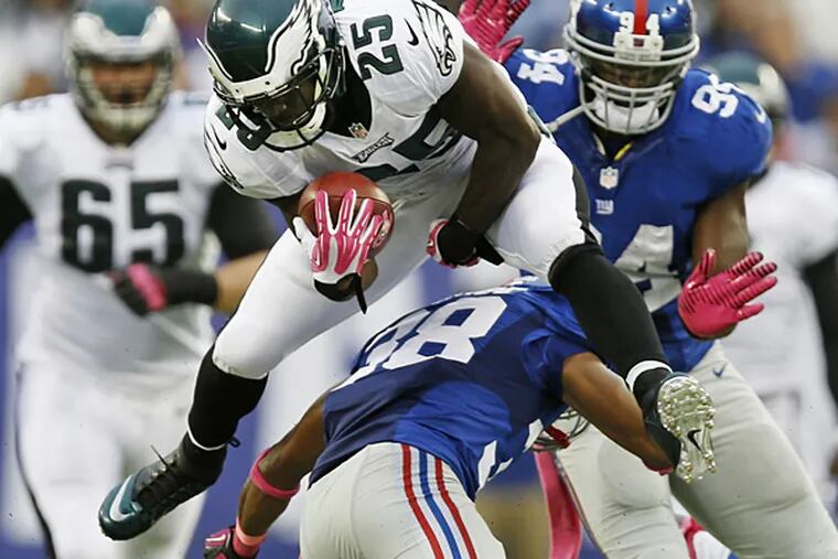Eagles running back LeSean McCoy leaps over the Giants' Trumaine McBride. (Kathy Willens/AP)