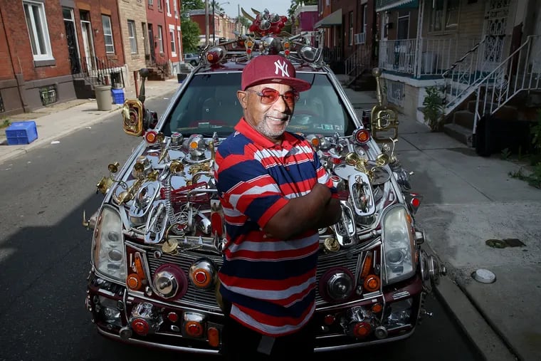 Gilbert Hilton poses for a portrait in front of his "Badillac" in 2019.