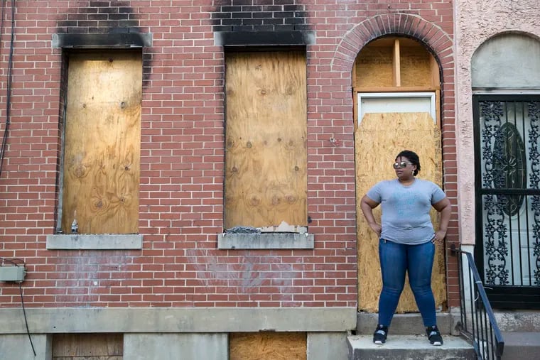 Shannon Driggins, 35, stands in front of 2246 N. Hancock on July 3, 2019.   Her grandmother bought the house in 1969.  Attempts were made to steal ownership of the house.