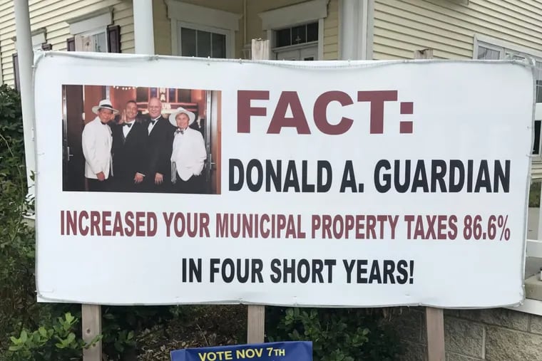 A banner outside a critic of Atlantic City Mayor Don Guardian features his husband and another prominent gay couple.