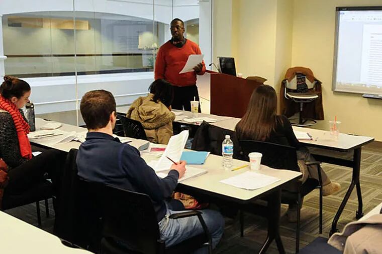 York Williams teaches a class at the Pennsylvania State System of Higher Education's little-known campus in the old Lit. Bros. building in Center City. (Ron Tarver/Staff)