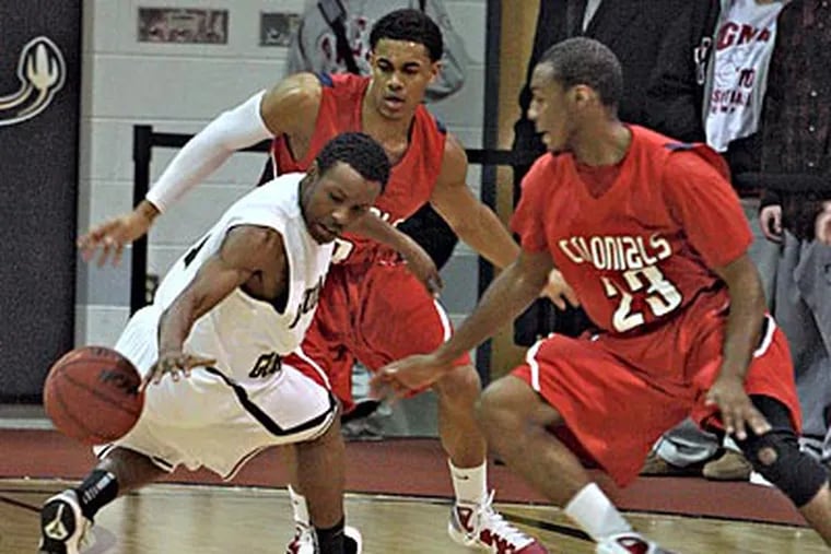 Players from Neumann-Goretti and Plymouth Whitemarsh look after a loose ball. (David M Warren / Staff Photographer)