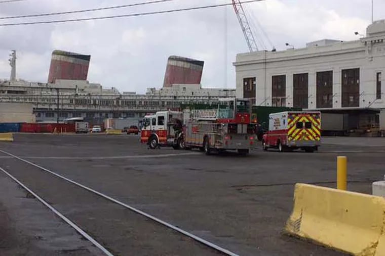 Emergency crews at the scene near the Delaware River where a body was found on a ship arriving in Philadelphia on May 11, 2015. (Jeff Gammage / staff)