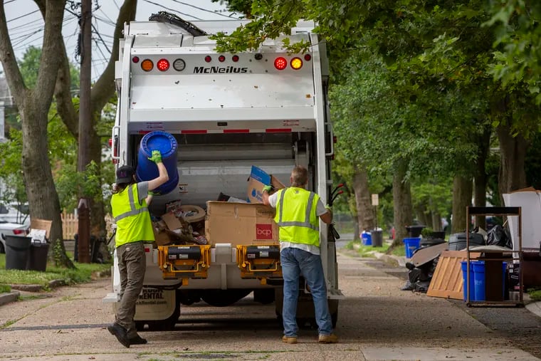 Municipal workers loaded a trash truck with recycling along Maple Avenue in Collingswood. Collingswood, New Jersey municipality restarted its municipal waste system because contractors were unable to get sufficient drivers. Photograph of municipal workers collecting recycling on Tuesday, June 22, 2021.