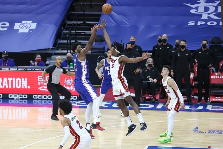 Joel Embiid hits a long two-point shot over Precious Achiuwa to force overtime in the Sixers' 137-134 victory against the Heat on Tuesday.