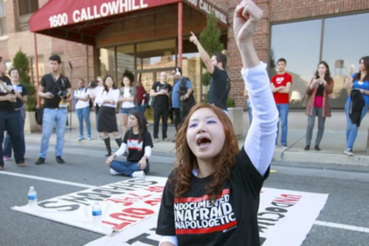 Jessica Hyejin Lee demonstrates at the ICE building in Philadelphia. She and Tania Chairez (seated in background), both illegal immigrants, were arrested. (David Swanson / Staff Photographer)