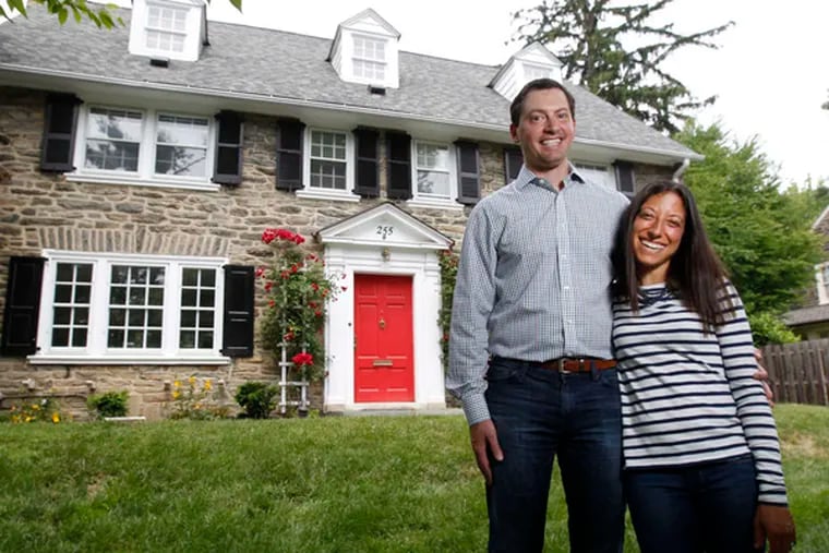Brett, left, and Jen, right, Cohen in front of their Wynnewood home. The Cohens' three-story stone Colonial was built in 1927.  ( Michael Bryant / Staff Photographer )