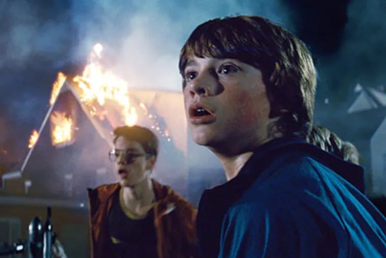 Joel Courtney (right) and Gabriel Basso in "Super 8," a sci-fi mystery set in an Ohio town in the summer of '79.