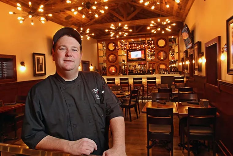 Eric Gantz, head chef at Tap House 23, a new high-end pub in Bridgeport, stands in the upstairs bar and dining room. ( Michael Bryant / Staff Photographer )