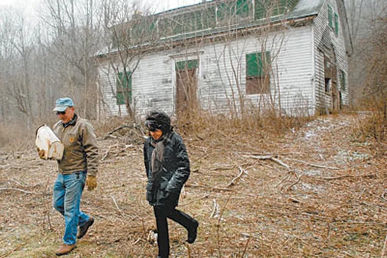 At her ancestral farm in Susquehanna County, settled in 1793, Denise Dennis strolls with caretaker John Arnone. Drillers have offered more than $800,000 for access to the Marcellus Shale. (TOM GRALISH / Staff Photographer)