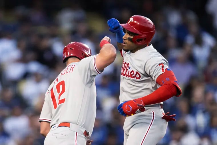 Philadelphia Phillies' Johan Camargo, right, and Kyle Schwarber celebrate Camargo's two-run home run against the Los Angeles Dodgers during the second inning of a baseball game in Los Angeles, Thursday, May 12, 2022. (AP Photo/Kyusung Gong)