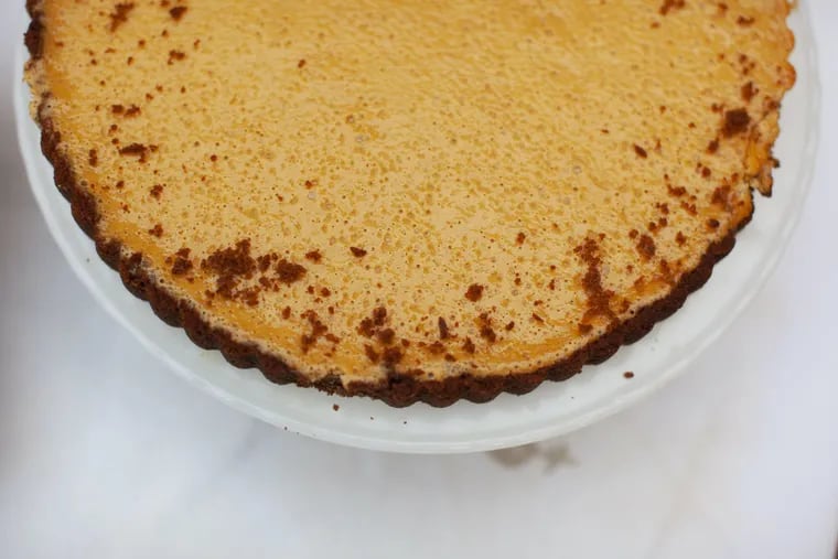 Pumpkin cheesecake tart in gingersnap crust, styled by Jamila Robinson.