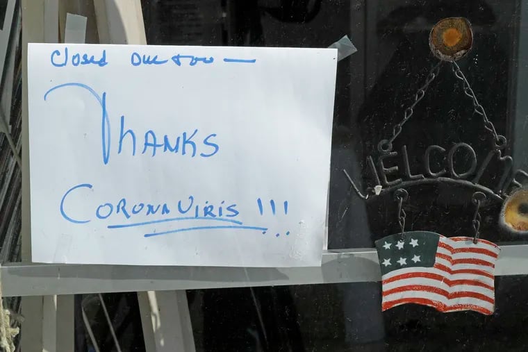 In this May 21, 2020 photo, a sign on a business in Tenino, Wash., says they are closed due to the coronavirus and state stay-at-home restrictions. But there is hope. A little-known part of the CARES Act has made loans for small businesses more affordable.  (AP Photo/Ted S. Warren)