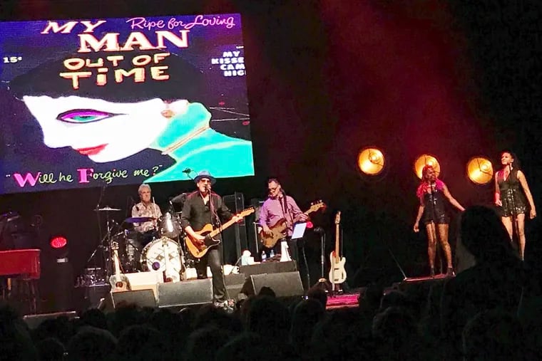 Elvis Costello &amp; the Imposters (left to right) with Peter Thomas, Elvis Costello, Davey Faragher, Kitten Kuroi and Briana Lee at the Tower Theater. (Not pictured: Steve Nieve.)