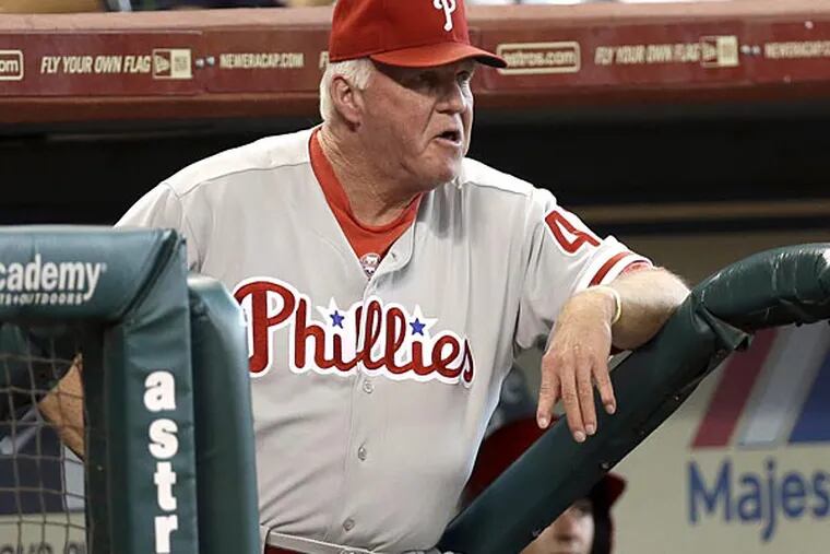 Philadelphia Phillies manager Charlie Manuel watches from the dugout during the second inning of a baseball game against the Houston Astros Sunday, Sept. 16, 2012, in Houston. (AP Photo/David J. Phillip)