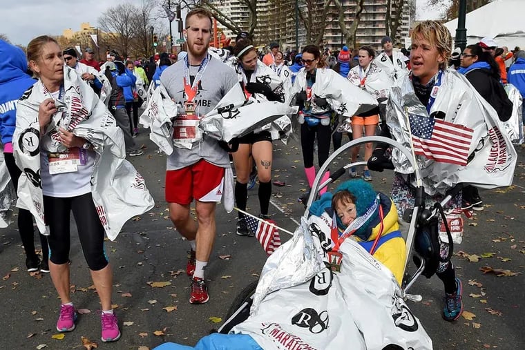 Kerry Gruson, 69, supported by runner Erin McCloskey (right) after finishing the Philadelphia Marathon. Gruson was strangled and left for dead in 1974.