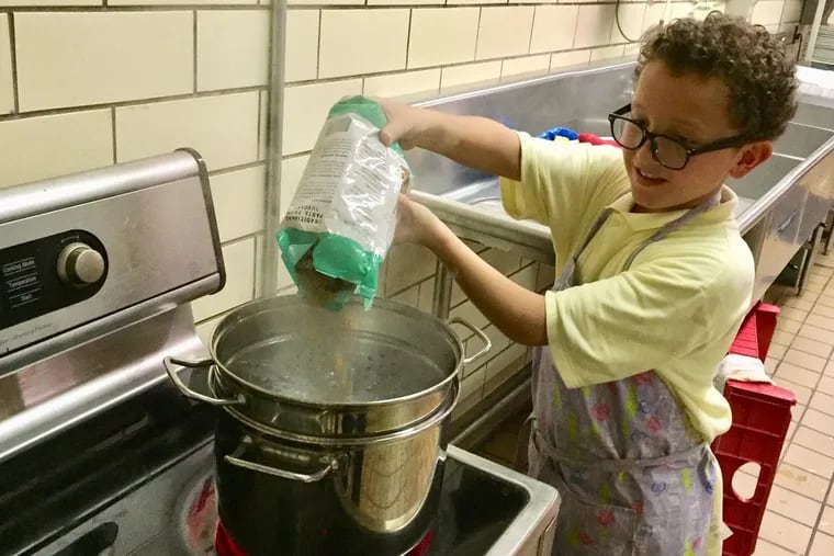 Bayard Taylor fifth grader Angel Luis Sanchez gets the pasta cooking during week 2 of the fall 2018 session of the My Daughter's Kitchen cooking program. Students learned to make tuna pasta salad.