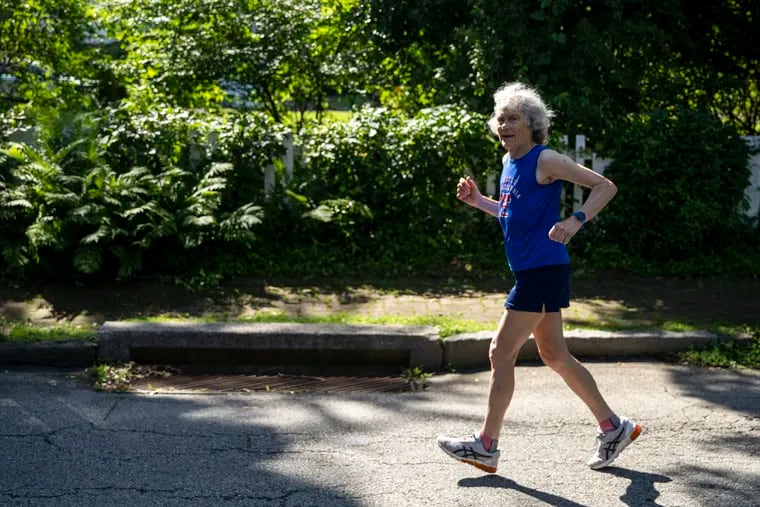 Sandy Folzer, 83, running near her home in Chestnut Hill, was one of the top finishers in this year's Broad Street Run when taking age into account.
