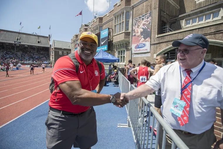 University of Houston track coach and former Olympian Leroy Burrell, left, is congratulated by Penn Relay official Joseph Ryan after Houston won their heat in the 4x200m at the Penn Relays last year.