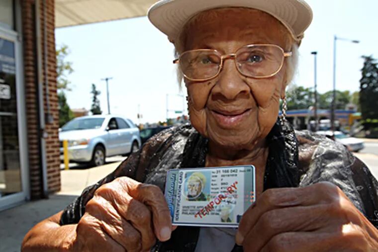 Viviette Applewhite, 93, holds up the temporary photo ID she was able to obtain from the Pennsylvania Department of Transportation. A permanent one will be mailed to her within 15 days. MICHAEL BRYANT / Staff