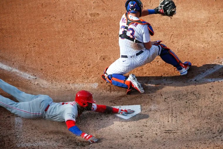 The Phillies' Odubel Herrera beats the throw to Mets catcher James McCann for a run during the sixth inning on Saturday, June 26, 2021, in New York.