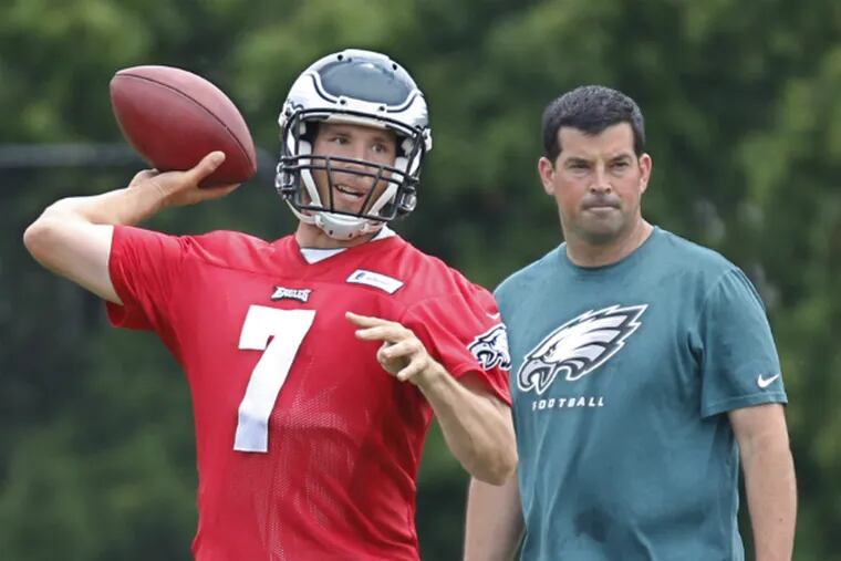 Sam Bradford throws passes during practice under the watchful eye of quarterback coach Ryan Day.