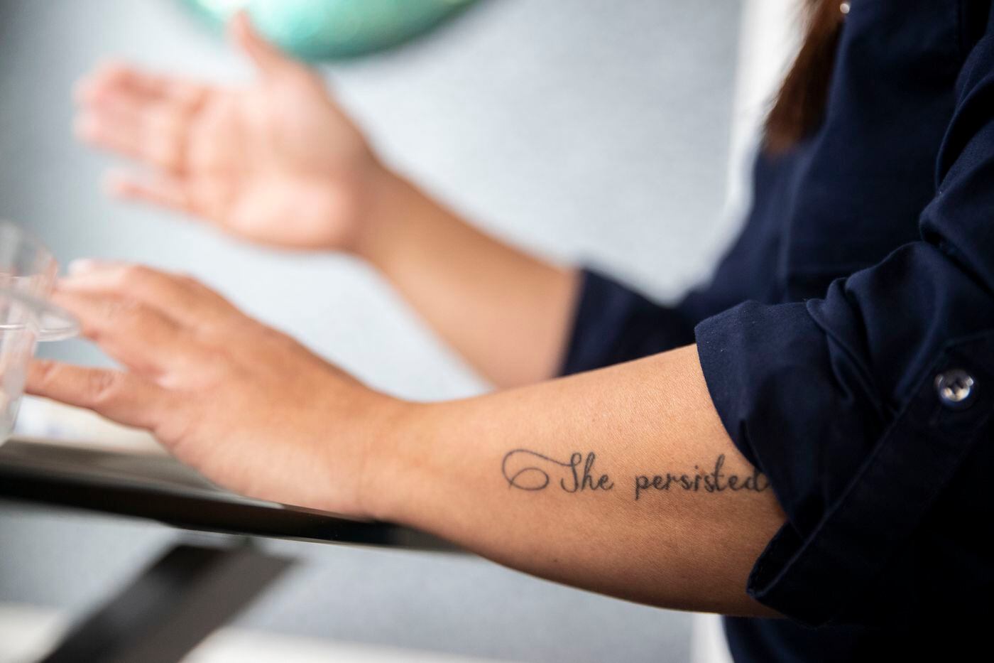 Uyen Khuong, executive director and co-founder of Action Together New Jersey, talks with a reporter at her home in Madison, New Jersey on Monday, November 25, 2019. Khuong has a tattoo that reads "She persisted" on her arm.