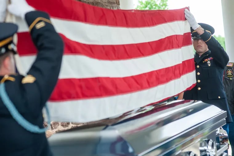 Sgt. Thomas Morris (left) of the Pennsylvania Military Funeral Honors Program and William Leuters (right) of 1067th Transportation Company fold the American flag that draped over the casket during funeral services for Army Sgt. Matthew Francis Kelly, 70, of Philadelphia Wednesday, July 10, 2019 at Washington Crossing National Cemetery in Upper Makefield, Pennsylvania. Kelly's wish was to be buried with full military honors and a welcome home parade, which upon his return from Vietnam he never received. WILLIAM THOMAS CAIN / For The Inquirer