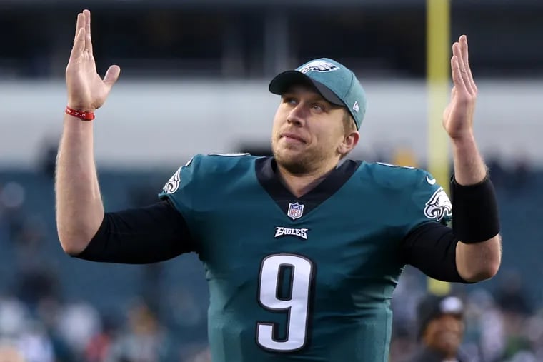 Nick Foles signals to the fans in the stands at Lincoln Financial Field after the Eagles beat the Texans.