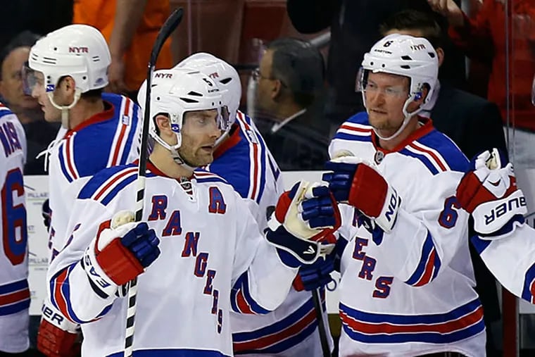 The Rangers' Dan Girardi celebrates with his teammates. (Yong Kim/Staff Photographer)