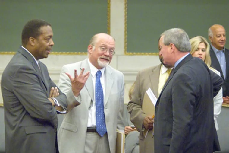 Council President Darrell Clarke, left talks with fellow councilmen William Greenlee, Curtis Jones (partially hidden) and James Kenney before Thursday's session. (Ed Hille / Staff Photographer)