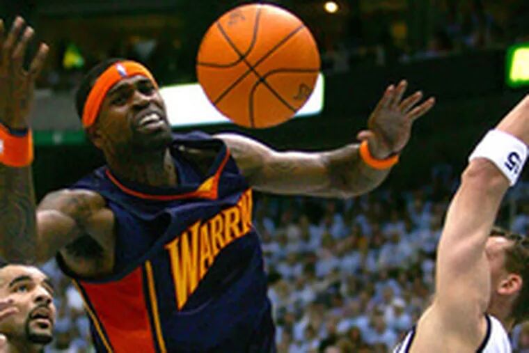 Golden State&#0039;s Stephen Jackson is fouled by Carlos Boozer (left) as Matt Harpring defends. Boozer scored 30 points as Utah took a lead of two games to none in the Western Conference series.