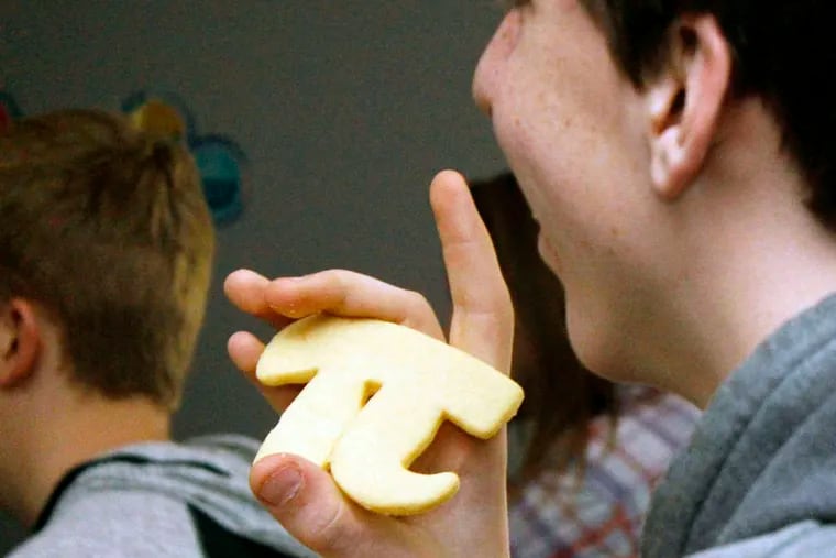 In Livingston, Mont., student David Noble holds a pi-shaped cookie he received for answering a question correctly on the eve of Pi Day. Livingston Enterprise
