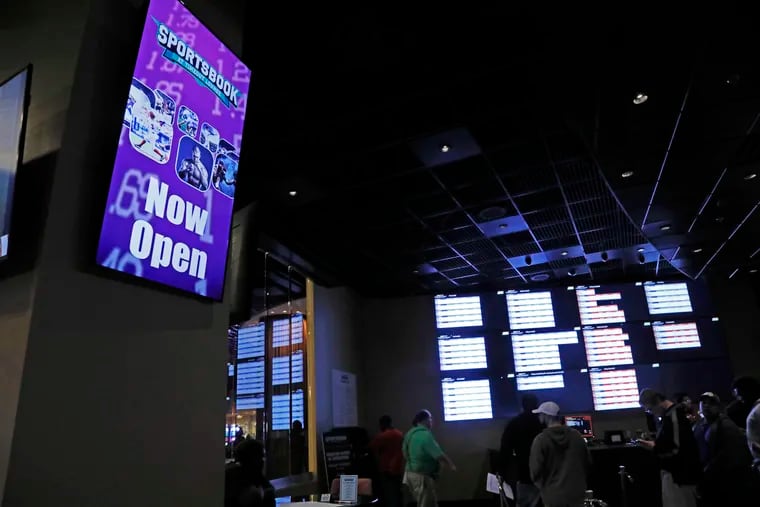 In this Dec. 18, 2018 photo, a "Now Open" sign is displayed at the Pearl River Resort in Philadelphia, Miss. The sports book owned by the Mississippi Band of Choctaw Indians is the first to open on tribal lands outside of Nevada following a U.S. Supreme Court ruling earlier this year, a no-brainer business decision given the sports fans among its gambling clientele. (AP Photo/Rogelio V. Solis)