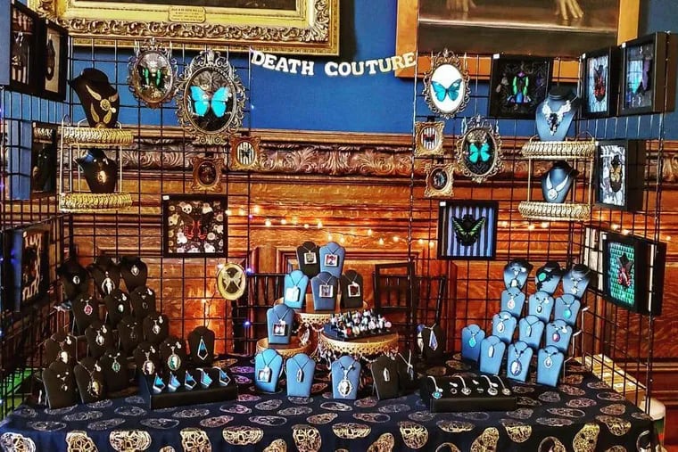 A display table at a previous Dr. Mütter's Merry Emporium of Death Couture creations by Philadelphia-area artisan Megg Ochsenbein. Some of her offerings included framed butterflies and moths and jewelry made with flowers picked from an empty lot in Milwaukee, Wis., where serial killer Jeffrey Dalmer's apartment was once located.