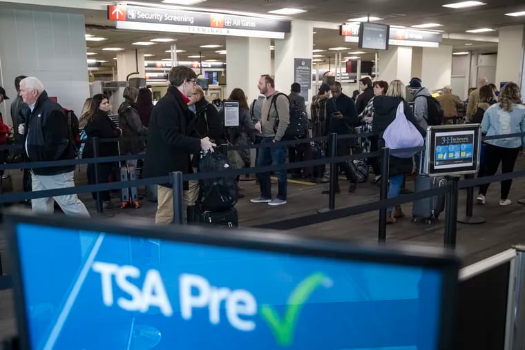 Passengers wait in line at a Transportation Security Administration checkpoint at the Philadelphia International Airport in Philadelphia, Friday, Jan. 11, 2019. (AP Photo/Matt Rourke)