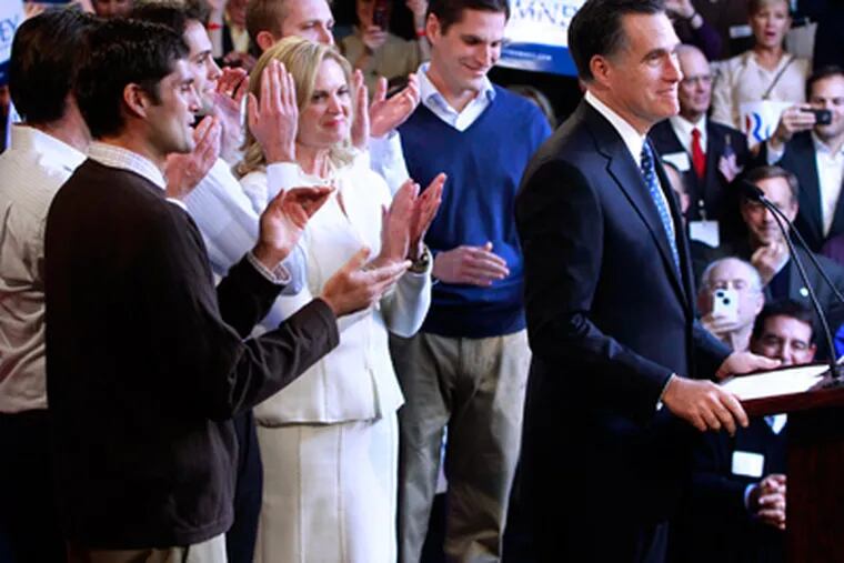 Mitt Romney addresses a primary-night party in Manchester, N.H., with his wife, Ann, and sons behind him. The former Massachusetts governor won New Hampshire’s Republican primary a week after his tight victory in the Iowa caucuses. (Charles Dharapak / Associated Press)